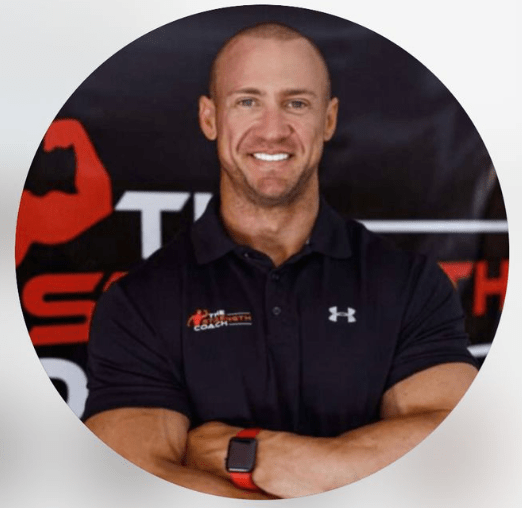 Man in gym uniform smiling confidently indoors