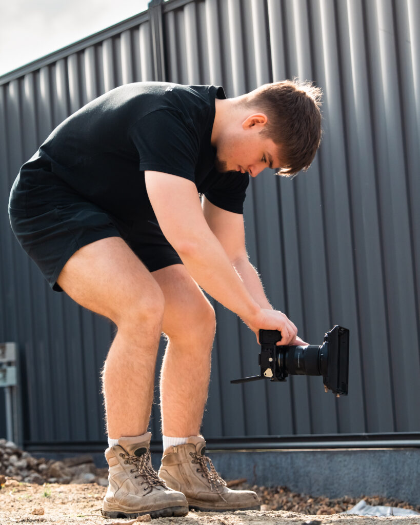 Hayden from Unreal Media filming on a construction site showing why Builders Need Video Marketing.